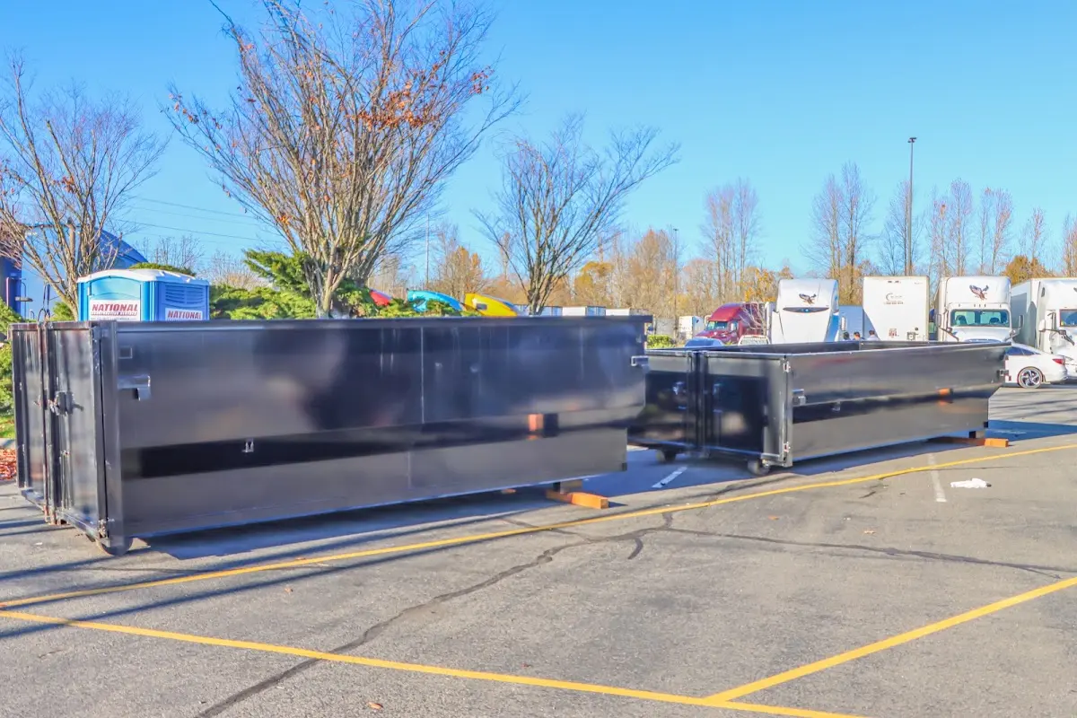 Professional dumpster rental service with roll-off container on residential driveway in Rye Brook